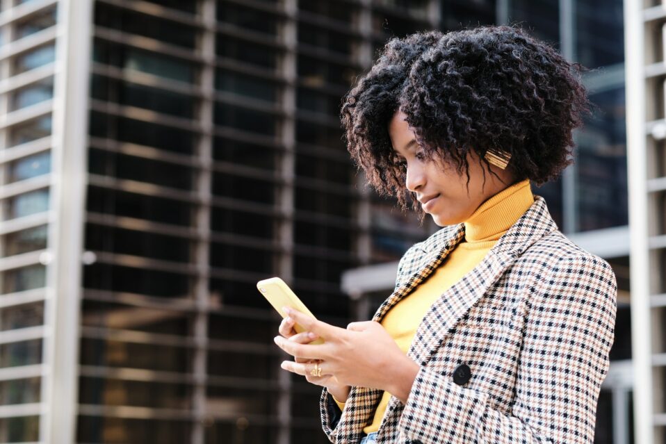 Business woman using her mobile phone outdoors.